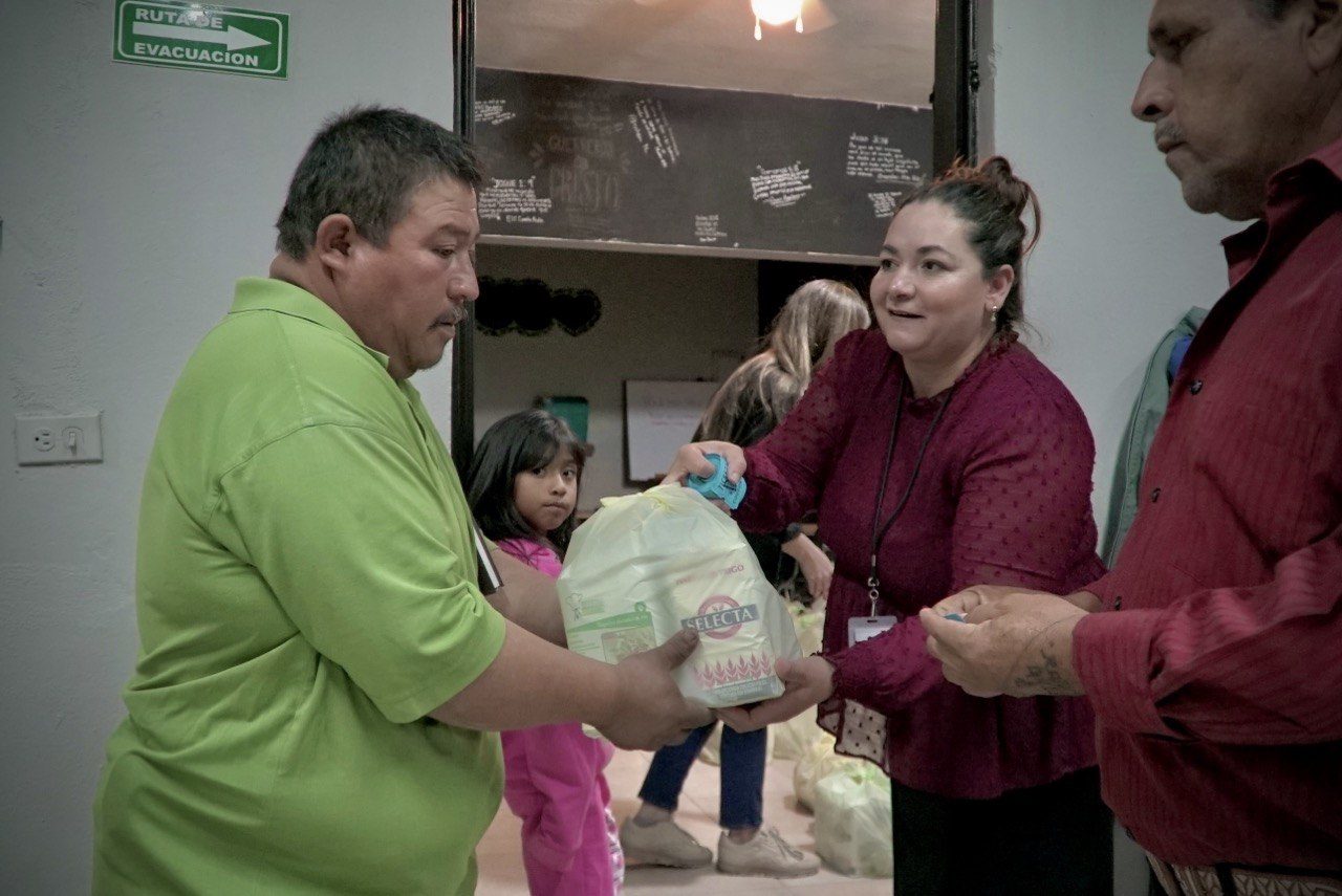Volunteer handing an aid package to a neighbor